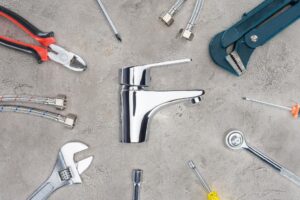 stock-photo-top-view-water-mixer-surrounded-various-tools-concrete-surface