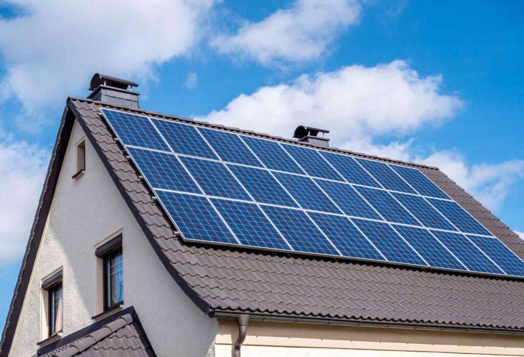 White-home-scallop-roof-and-solar-panels-shutterstock_1336991930-scaled-1-scaled